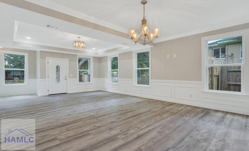 Open concept living/dining room area with crown mo