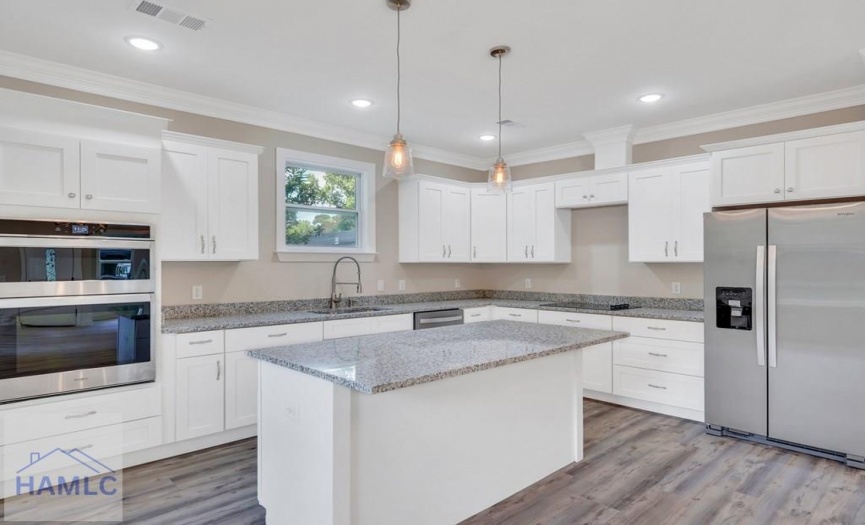 Open Concept Kitchen with an Island & Granite Coun